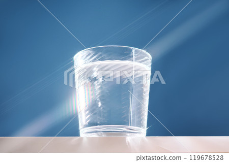 Glass of clean filtered water on blue background with beautiful glare. Glass of clean filtered water on blue background with beautiful glare. 119678528