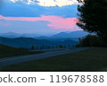 Scenic mountain road at twilight with colorful sunset sky 119678588