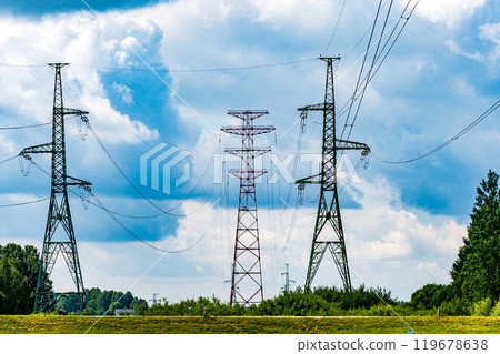 A view of electric power transmission lines stretching across a cloudy sky and scenic landscape in the countryside A view of electric power transmission lines stretching across a cloudy sky and scenic landscape in the countryside 119678638