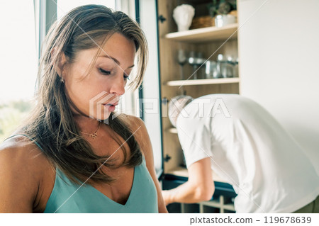 A couple actively collaborates in the kitchen, showcasing the importance of teamwork and modern home life A couple actively collaborates in the kitchen, showcasing the importance of teamwork and modern home life 119678639