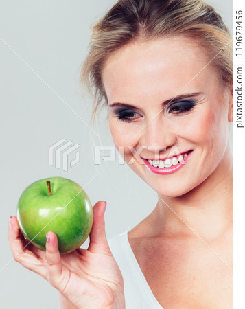 Fit woman holding apple fruit, dieting concept Fit woman holding apple fruit, dieting concept 119679456