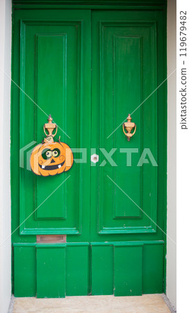 Green door decorated with a pumpkin. Backgrounds Green door decorated with a pumpkin. Backgrounds 119679482