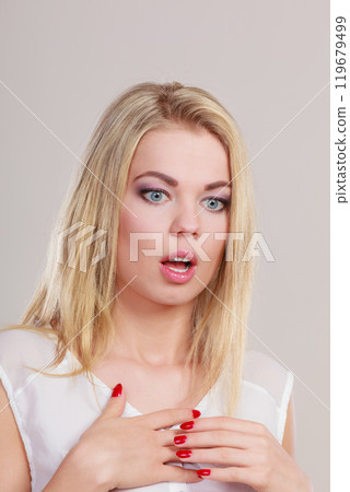 Surprised shocked woman face with open mouth 119679499