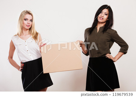 two women with blank board two women with blank board 119679539