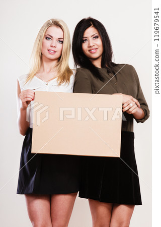 two women with blank board two women with blank board 119679541