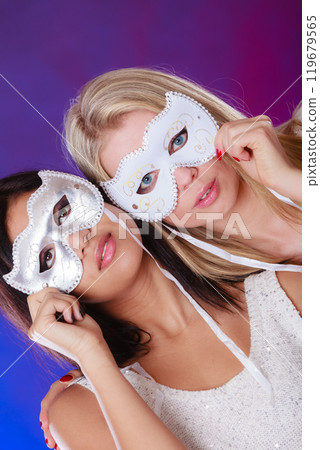 Two women face with carnival venetian masks Two women face with carnival venetian masks 119679565