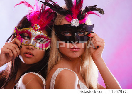 Two women with carnival venetian masks Two women with carnival venetian masks 119679573