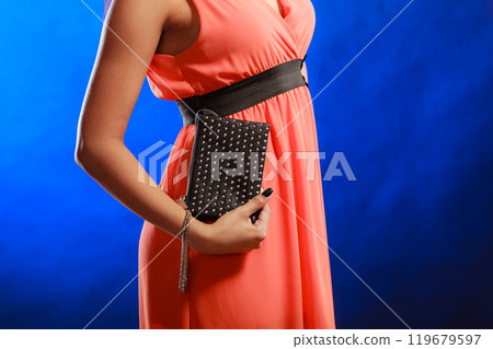 Evening handbag in woman hand Evening handbag in woman hand 119679597