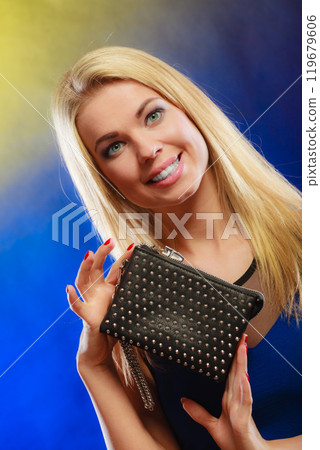 Elegant woman holds black handbag Elegant woman holds black handbag 119679606