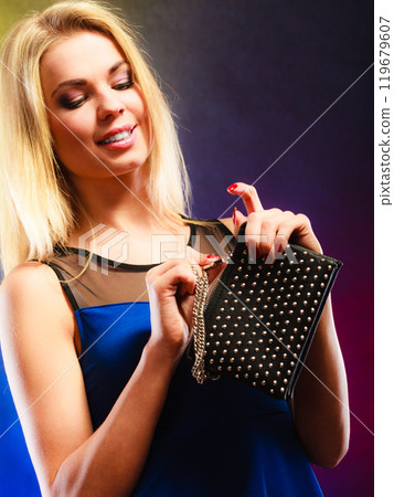 Elegant woman holds black handbag 119679607