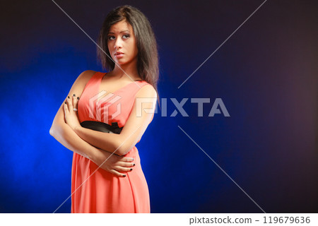 mixed race girl in party dress on blue 119679636