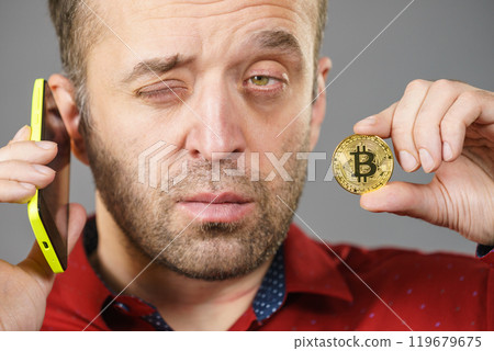 Man with bitcoin talking on phone Man with bitcoin talking on phone 119679675
