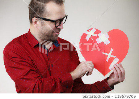 Man holding broken heart 119679709