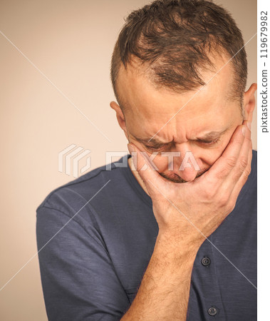 Sad worried man covering his mouth 119679982