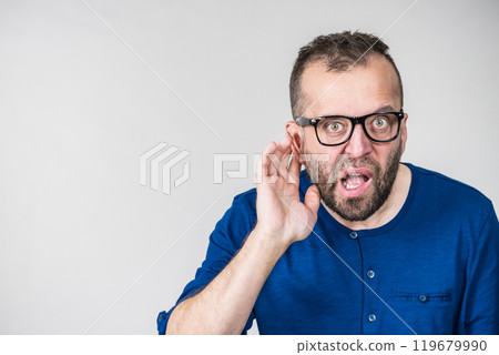 Man eavesdropping with hand close to ear Man eavesdropping with hand close to ear 119679990