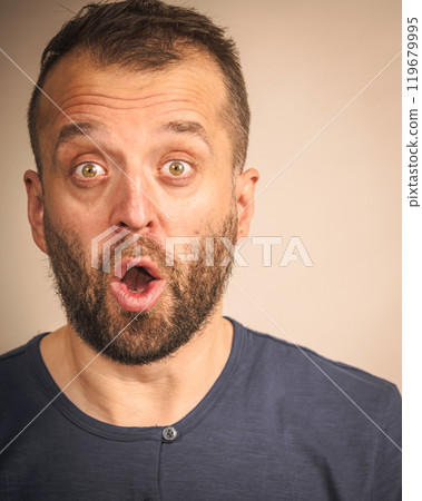 Astonished shocked adult man Astonished shocked adult man 119679995