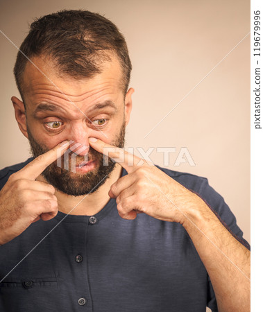 Man smelling bad scent Man smelling bad scent 119679996