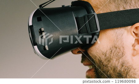 Adult man wearing vr goggles 119680098