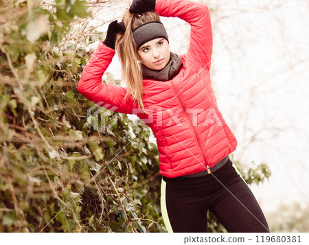 Woman wearing sportswear during winter Woman wearing sportswear during winter 119680381