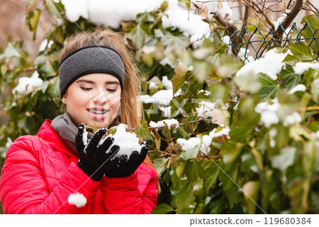 Happy woman playing with snow 119680384
