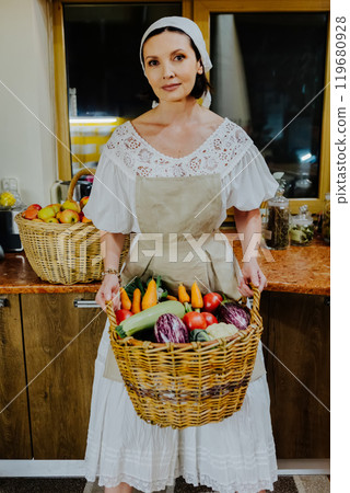 Woman dressed in a traditional white dress and apron Woman dressed in a traditional white dress and apron 119680928