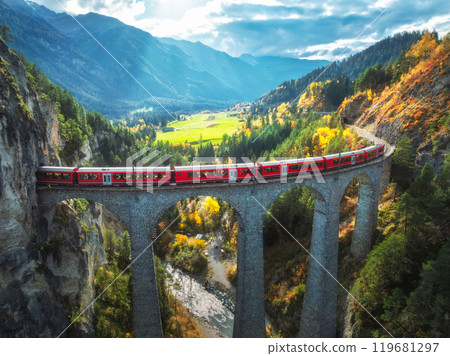 Aerial view of red train on Landwasser viaduct in autumn in Alps 119681297