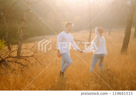 Young couple having fun walking and hugging n the park. Autumn weather. Relaxation, youth. 119681515