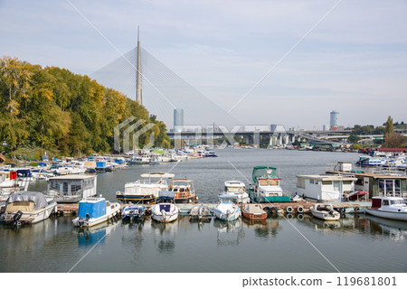 Boat marina at Ada Ciganlija with Ada Bridge, a cable-stayed bridge over the Sava river in Belgrade, Serbia 119681801