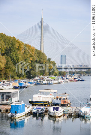 Boat marina at Ada Ciganlija with Ada Bridge, a cable-stayed bridge over the Sava river in Belgrade, Serbia 119681803