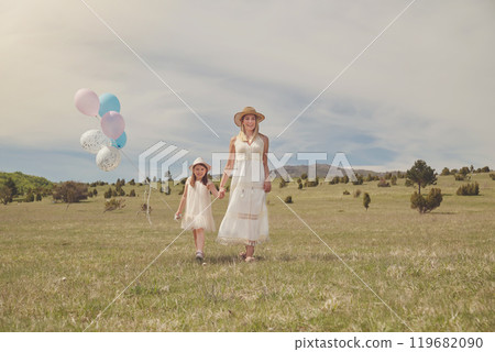 Young mother and her daughter having fun in nature park 119682090