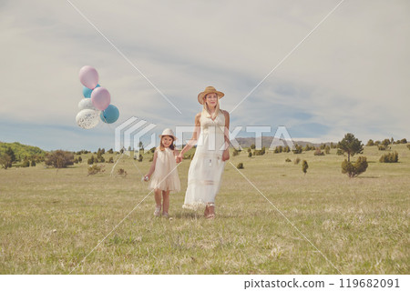 Young mother and her daughter having fun in nature park 119682091