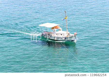 Small fishing boat on the crystal clear beach of Corfu, Greece Small fishing boat on the crystal clear beach of Corfu, Greece 119682254