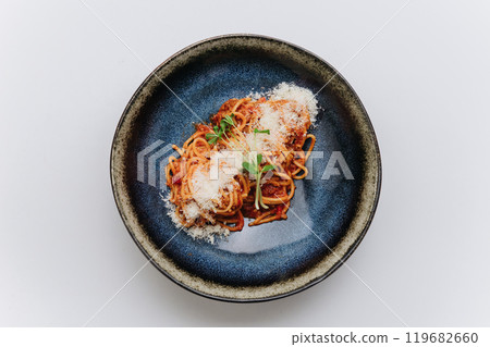 Classic spaghetti Bolognese topped with Parmesan, comforting and flavorful Italian meal 119682660