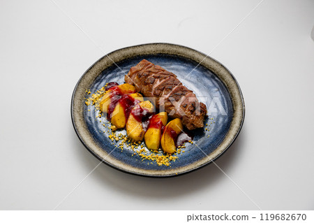 Grilled duck breast with roasted apples and berry sauce, beautifully plated with nut crumble garnish 119682670