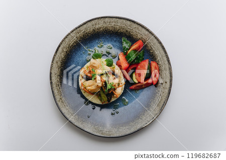 Grilled chicken with vegetables and fresh tomato cucumber salad for a healthy and balanced meal 119682687