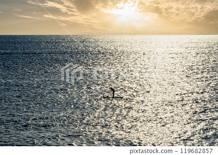 Silhouette of a woman practicing paddle surfing in Menorca at sunset. Balearic Islands 119682857