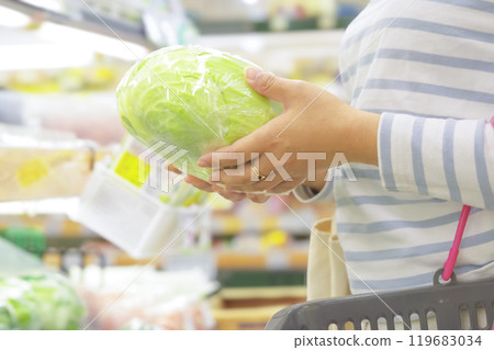 Woman buying groceries at the supermarket 119683034
