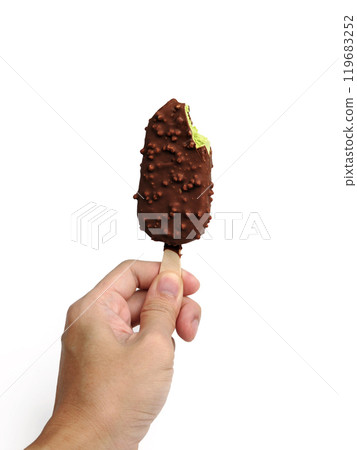 A man holding a green tea ice cream bar coated in chocolate with a bite taken out. 119683252