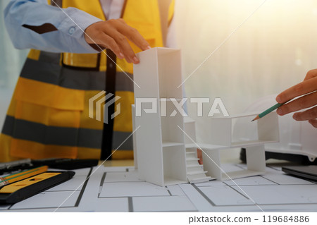 Construction and structure concept of Engineer or architect meeting for project working with partner and engineering tools on model building and blueprint in working site, contract for both companies. 119684886