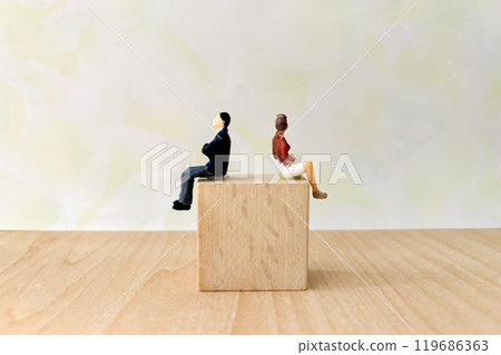 Man and woman sitting back to back Man and woman sitting back to back 119686363