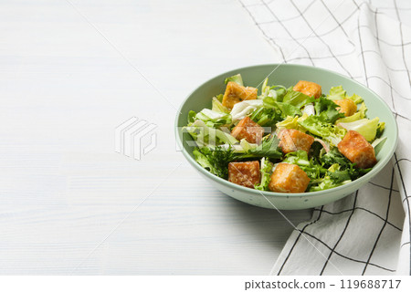 Fried tofu salad in a bowl on a white background Fried tofu salad in a bowl on a white background 119688717