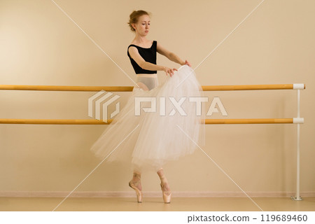 A ballet dancer showcases a dynamic pose 119689460