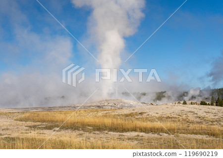 Steam emitting from Old Faithful on a cold fall day in Yellowstone National Park Steam emitting from Old Faithful on a cold fall day in Yellowstone National Park 119690219