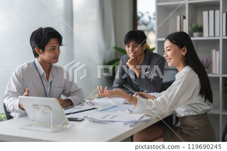 Asian Business Team Meeting for Idea Exchange and Discussion in Modern Office Setting Asian Business Team Meeting for Idea Exchange and Discussion in Modern Office Setting 119690245