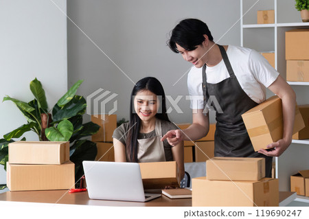Online Selling Couple Taking Orders and Packing Products in Home Office Online Selling Couple Taking Orders and Packing Products in Home Office 119690247