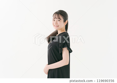 Portrait of a woman in her twenties wearing a black dress Portrait of a woman in her twenties wearing a black dress 119690356