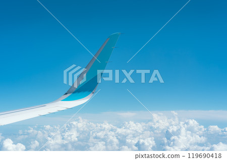 View of an airplane wing and blue sky 119690418