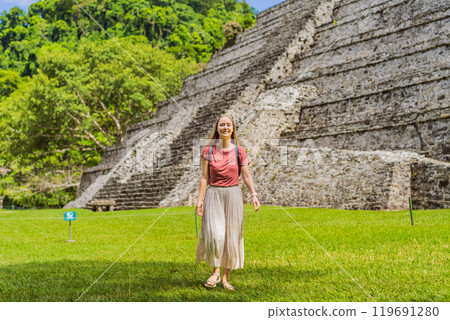 Female tourist exploring the ancient pyramids of Palenque, Mexico, surrounded by dense jungle. Cultural heritage and adventure travel concept Female tourist exploring the ancient pyramids of Palenque, Mexico, surrounded by dense jungle. Cultural heritage and adventure travel concept 119691280