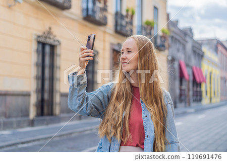 Female tourist walking through the colorful colonial streets of Puebla, Mexico. Travel, cultural exploration, and vibrant architecture concept 119691476