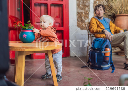 Father and his son tourists in a colonial house in San Cristobal de las Casas, Mexico. Cultural exploration, architecture, and travel experience concept 119691586